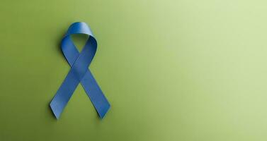 Prostate Cancer Awareness Campaign Concept. Men Healthcare. Close up of a Blue Ribbon Lying on Green background, Top View photo