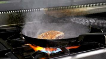 Delicious piece of duck breast meat frying in pan on restaurant kitchen video