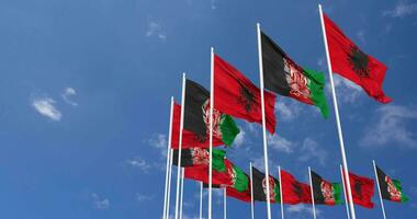 Afghanistan and Albania Flags Waving Together in the Sky, Seamless Loop in Wind, 3D Rendering video