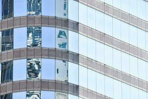 reflections of the city in the windows of a building photo