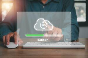 Backup concept, Business person hand touching backup icon on cirtual screen. photo