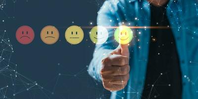 a businessman touching the virtual screen on the happy smile face icon to give satisfaction in service.Customer service and Satisfaction concept.rating very impressed. photo