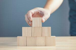 hand of a businessman stacking wood empty eight blocks with copy space for text or symbols, development concept for growth success process. photo