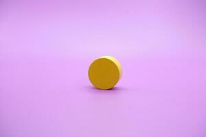 yellow wooden shape toy. Round on Purple background photo