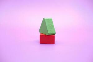 Set of colorful wooden shape toy. Square and triangle on Purple background photo