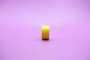 yellow wooden shape toy. Round on Purple background photo