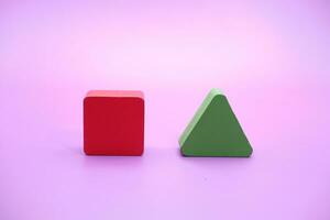 Set of colorful wooden shape toy. Square and triangle on Purple background photo