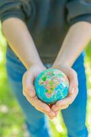 Human hands holding global earth ball. Sustain earth concept. Love nature. Save the planet. photo