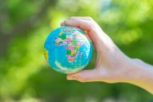 Human hands holding global earth ball. Sustain earth concept. Love nature. Save the planet. photo