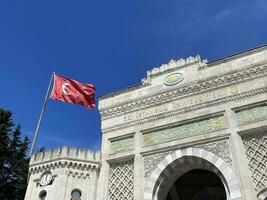 14 of April 2023 - Istanbul, Turkey - Istanbul University, the main entrance with national flags photo