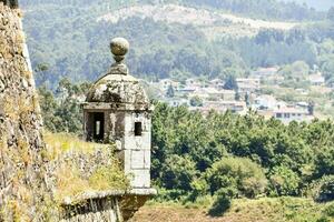 a view of the town and mountains from the top of a wall photo