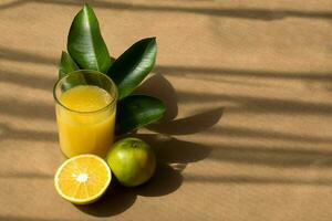 Fresh orange juice with fruit on a rustic background and space for text on the right side photo