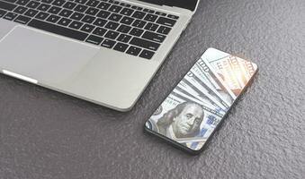 Dollar banknotes image inside of smartphone screen with laptop on gray stone tabletop, business and financial online design concept photo