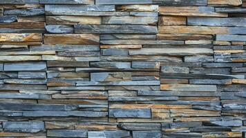 Background and texture of multicolor cladding stone slate wall in loft style photo