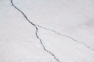 Crack texture on concrete pavement floor surface background photo