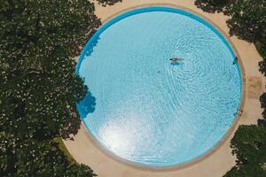 Top view of woman swimming in swimming pool minimal concept. photo