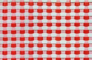 Colorful red and white weave pattern background of recycled plastic basket, recycle concept photo