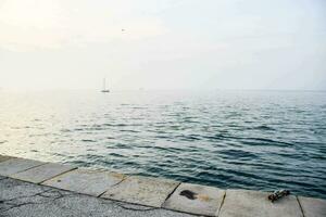 a concrete wall near the water photo