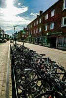 bikes parked on the side of a street in front of buildings photo