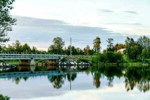 a bridge over a river in the middle of a town photo