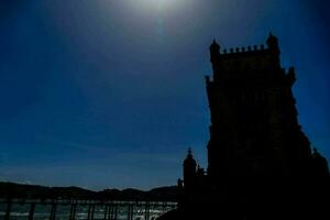 the sun shines brightly over the tower of belem photo