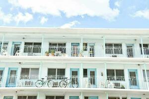 a white building with blue doors and bikes photo