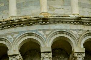 the top of a building with arches and columns photo