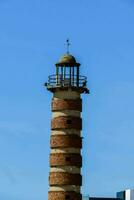 a lighthouse tower with a bird on top photo