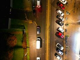 Aerial View of Illuminated Road and Traffic Roundabout at Barnfield College A6 East Luton City of England UK. The Footage Was Captured with Drone's Camera on November 11th, 2023 photo