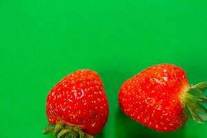 Ripe strawberry on a green background photo