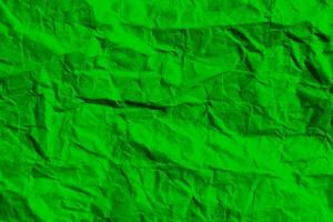 Wrinkled green paper texture background. Crumpled paper surface. photo