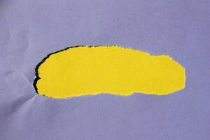 Purple torn paper background. Ripped paper on yellow background with copy space for text. photo