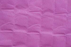 Creased pink paper texture as background photo