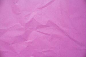 Creased pink paper texture as background photo