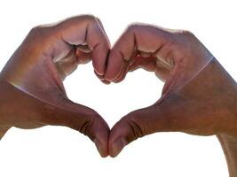 Close up of male hands showing heart on white background photo