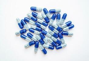 Closeup blue pills on white background. Medicine and healthcare concept photo