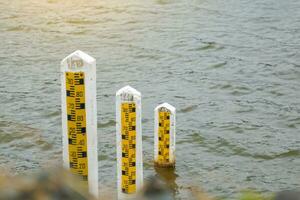 There are 3 sizes of cement poles to measure the water level in the reservoir to measure large amounts of water in the rainy season. and less water in the dry season. Soft and selective focus. photo