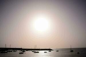 the sun is shining brightly over a body of water photo