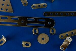 various metal parts on a blue surface photo