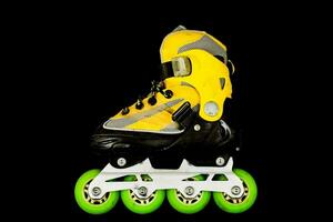 a yellow inline skate with green wheels photo