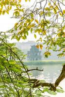 Hoan Kiem Lake - Ho Guom or Sword lake in the center of Hanoi in the fog in the morning. photo