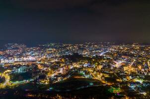 Aerial view of a Da Lat City with development buildings, transportation. Tourist city in developed Vietnam. Center Square of Da Lat city with Xuan Huong lake and market. photo