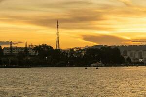 Sunset view of a Da Lat City with development buildings, transportation, market. Tourist city with center square of Da Lat city near Xuan Huong lake photo