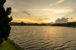 Sunset view of a Da Lat City with development buildings, transportation, market. Tourist city with center square of Da Lat city near Xuan Huong lake photo