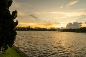 Sunset view of a Da Lat City with development buildings, transportation, market. Tourist city with center square of Da Lat city near Xuan Huong lake photo