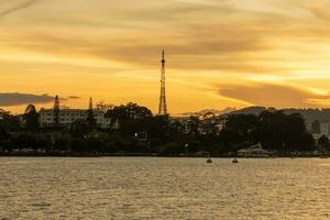 Sunset view of a Da Lat City with development buildings, transportation, market. Tourist city with center square of Da Lat city near Xuan Huong lake photo