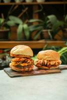 two chicken burger on wooden table photo