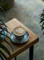 a cup of cappuccino on the table photo