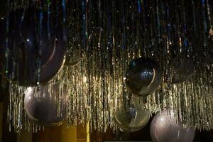 ceiling with silver balloons and foil rain. photo