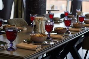 table setting glasses with compote, plates salad photo